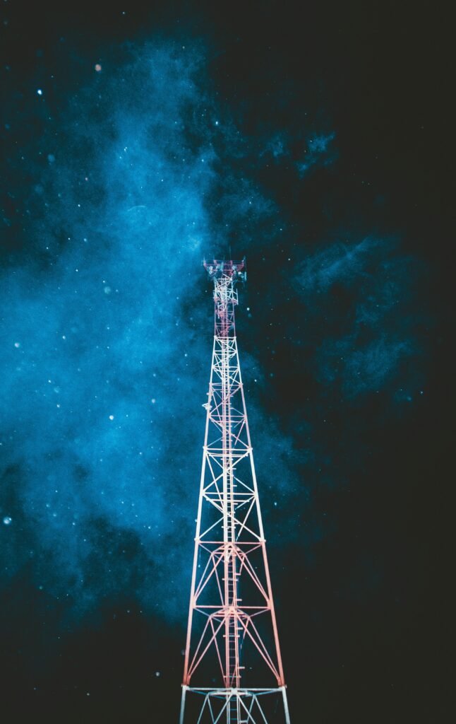 pexels-photo-2352277-2352277 A striking telecommunication tower stands beneath a vibrant starry night sky.